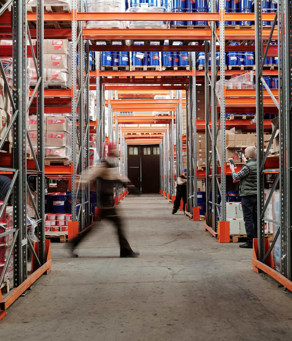 Man walking purposefully through a logistics warehouse, where Temera’s innovation streamlines every operation. With the RFID system, each product is accura